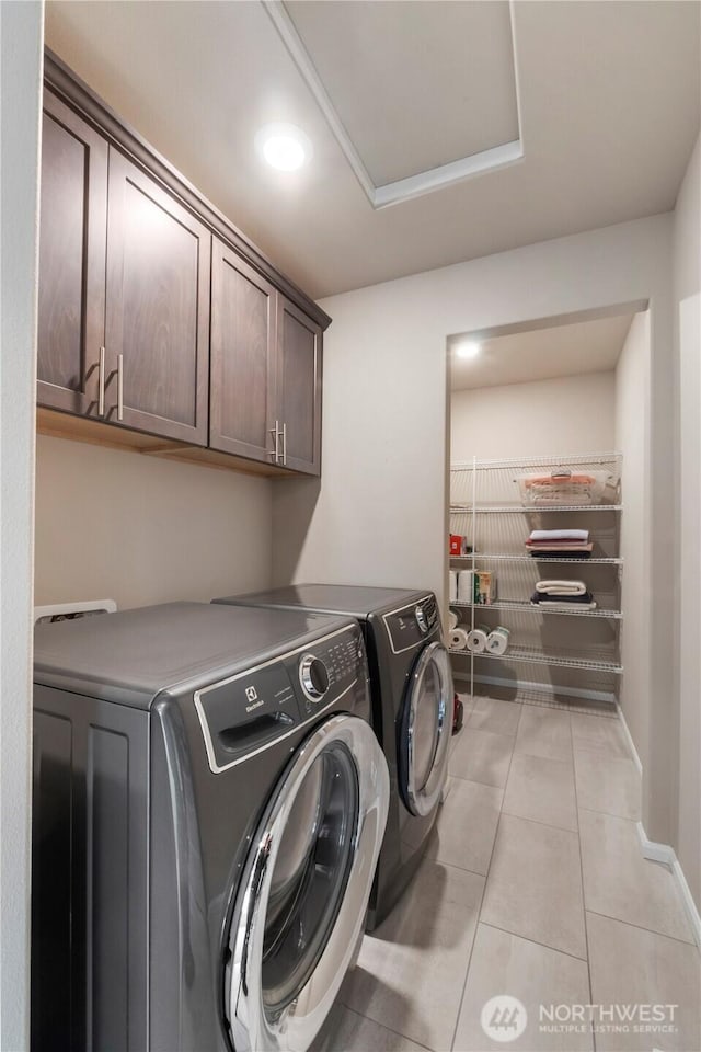 26334 203rd Pl SE, Covington, WA 98042 - laundry room featuring cabinet space, washing machine and clothes dryer, and light tile patterned floors