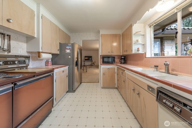 kitchen with range, dishwashing machine, light floors, black microwave, and a sink