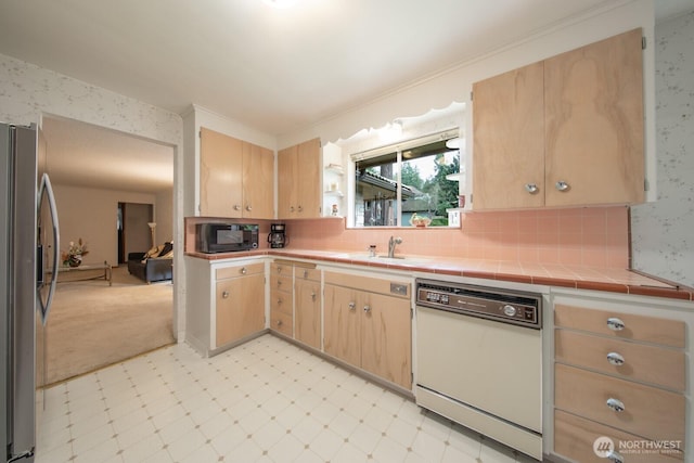 kitchen with light brown cabinets, black microwave, stainless steel refrigerator with ice dispenser, light floors, and white dishwasher