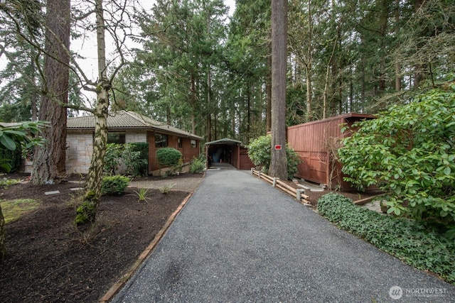 view of front of property with a tiled roof and an outbuilding