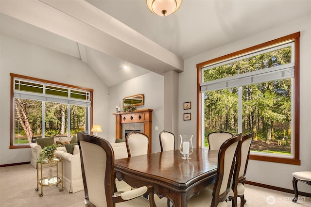 27909 SE 268th St, Ravensdale, WA 98051 - dining room featuring baseboards, lofted ceiling, a tiled fireplace, and light colored carpet