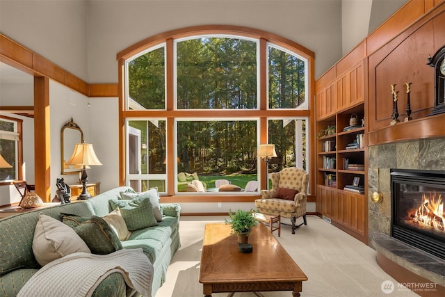 27909 SE 268th St, Ravensdale, WA 98051 - living room with a towering ceiling, a healthy amount of sunlight, a tiled fireplace, and light colored carpet