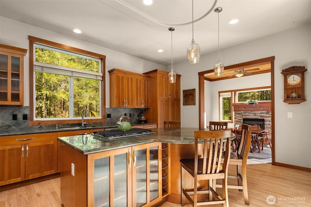 27909 SE 268th St, Ravensdale, WA 98051 - kitchen featuring a sink, stainless steel gas stovetop, plenty of natural light, and brown cabinetry