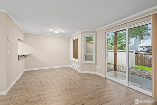 1700 Lake Park Dr SW Unit 8, Tumwater, WA 98512 - empty room featuring light wood-style flooring, crown molding, baseboards, and a baseboard heating unit