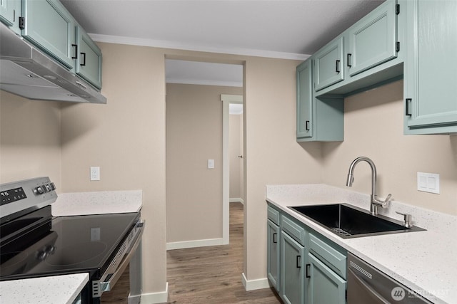 1700 Lake Park Dr SW Unit 8, Tumwater, WA 98512 - kitchen with a sink, wood finished floors, appliances with stainless steel finishes, under cabinet range hood, and ornamental molding