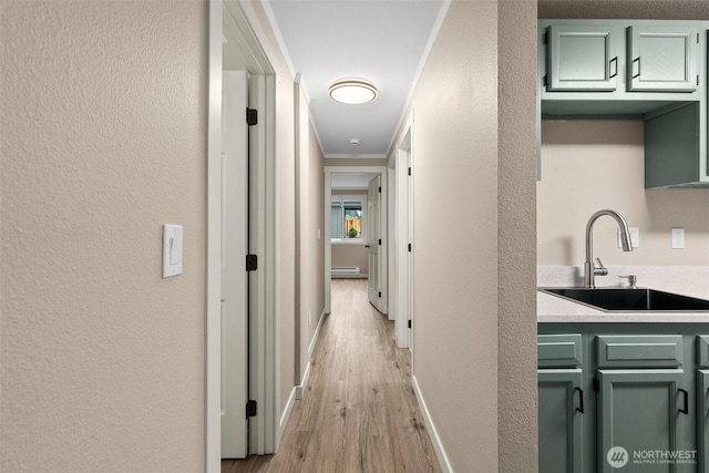 1700 Lake Park Dr SW Unit 8, Tumwater, WA 98512 - corridor with a sink, light wood finished floors, baseboards, a baseboard heating unit, and ornamental molding