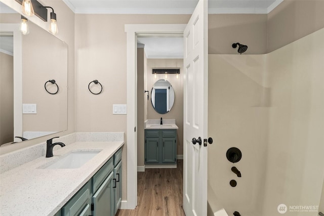 1700 Lake Park Dr SW Unit 8, Tumwater, WA 98512 - bathroom with crown molding, wood finished floors, a sink, and two vanities