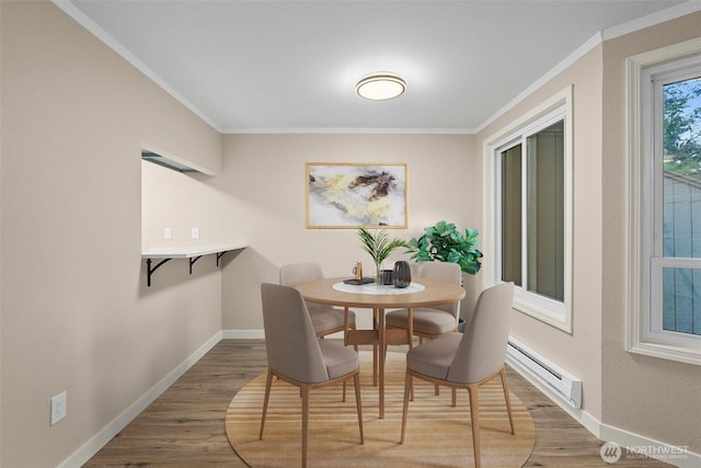 1700 Lake Park Dr SW Unit 8, Tumwater, WA 98512 - dining room with a baseboard radiator, crown molding, wood finished floors, and baseboards