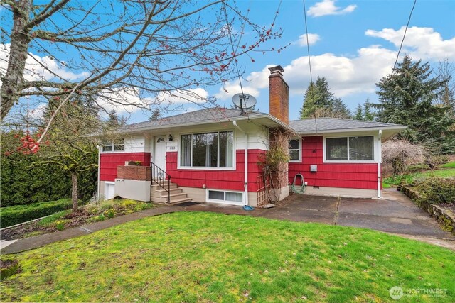 single story home with a front lawn, a chimney, and a shingled roof