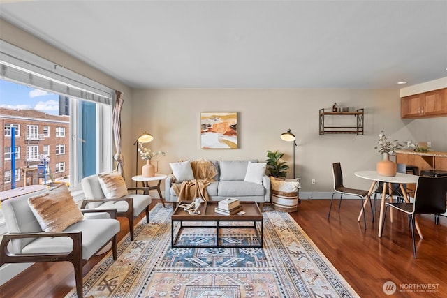 living room featuring baseboards and wood finished floors