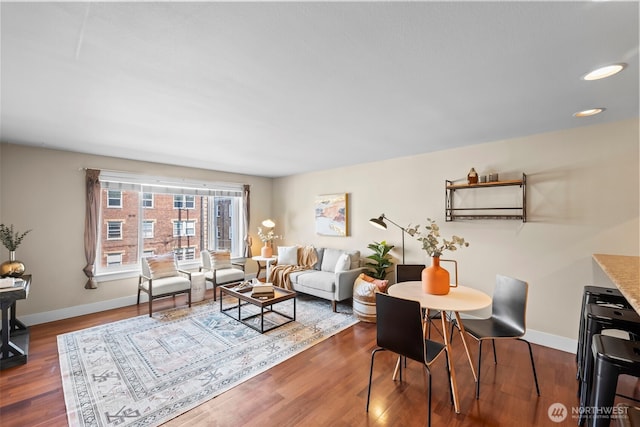 living area featuring recessed lighting, baseboards, and wood finished floors