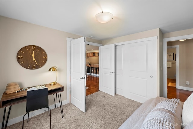carpeted home office featuring baseboards