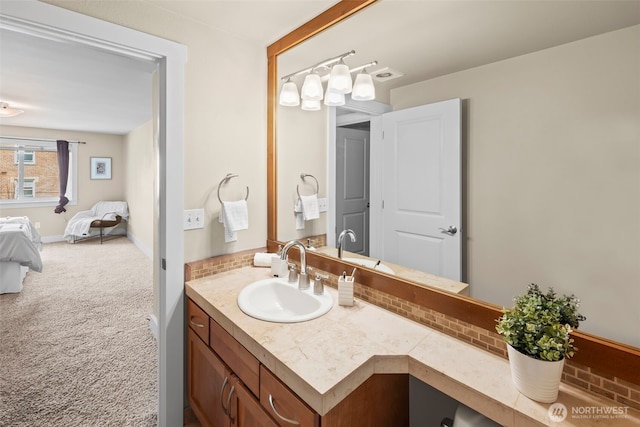 ensuite bathroom featuring backsplash, vanity, connected bathroom, and baseboards