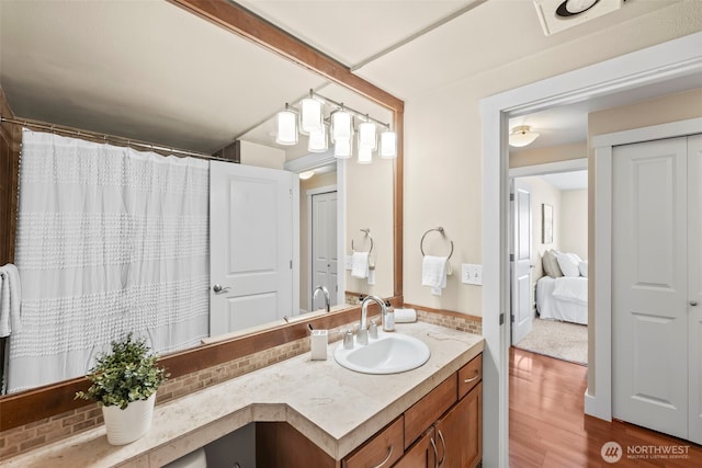 bathroom with wood finished floors and vanity