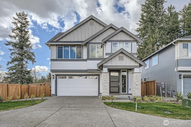 view of front of property with board and batten siding, concrete driveway, a garage, and fence