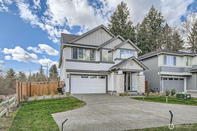 craftsman inspired home featuring stone siding, a garage, board and batten siding, fence, and driveway