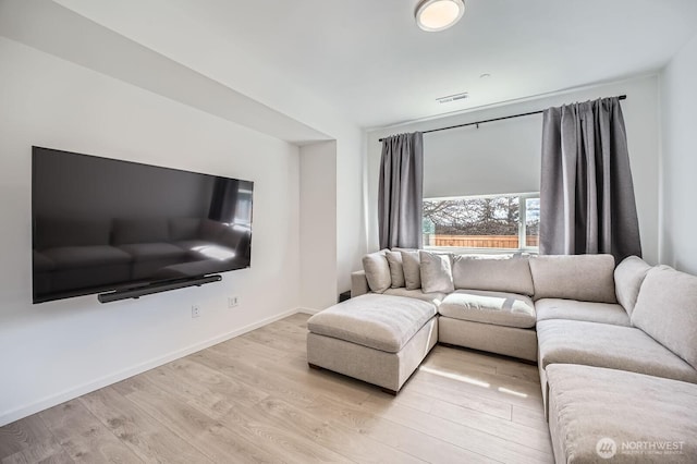 living room with light wood-style flooring and baseboards