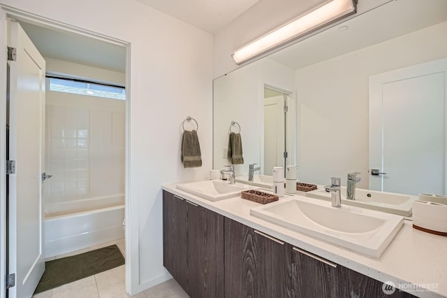 bathroom with double vanity, a sink, and tile patterned flooring
