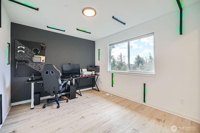 office space featuring baseboards and wood finished floors