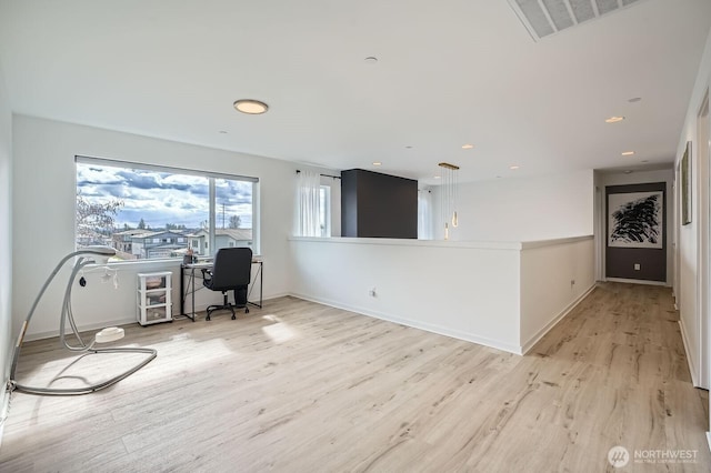 unfurnished office with visible vents, baseboards, and light wood-style floors