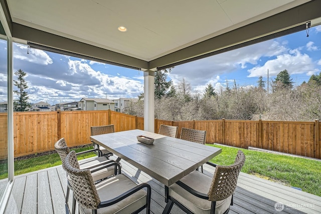 deck featuring outdoor dining space and a fenced backyard