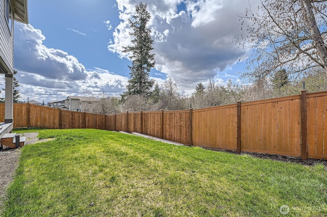 view of yard with a fenced backyard