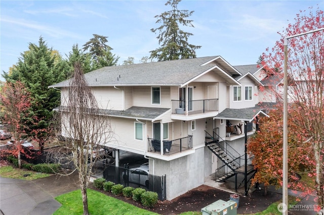 10240 Bridgeport Way SW, Lakewood, WA 98499 - exterior space with a balcony, stairs, and roof with shingles