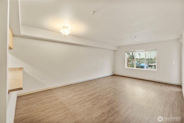 10240 Bridgeport Way SW, Lakewood, WA 98499 - unfurnished room with baseboards and wood finished floors