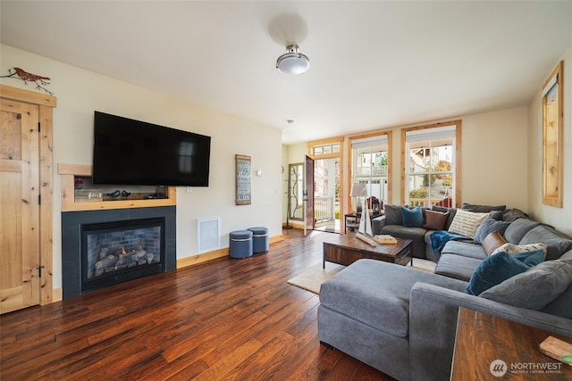 540 Porcupine Ln, Chelan, WA 98816 - living room with baseboards, visible vents, a lit fireplace, and dark wood finished floors