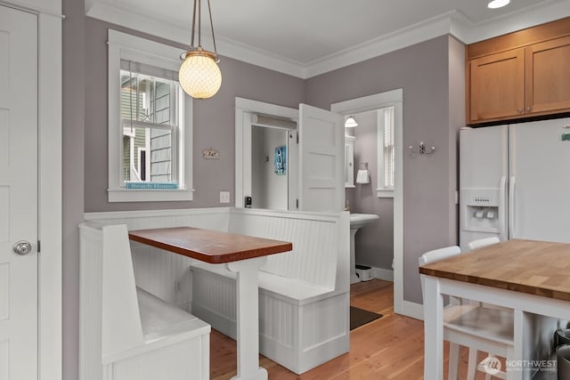 32 Madison Ln, Pacific Beach, WA 98571 - dining space featuring light wood-type flooring, crown molding, and breakfast area