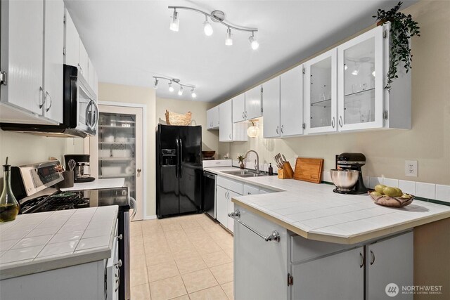 12427 129th Ave E, Puyallup, WA 98374 - kitchen featuring a sink, tile counters, a peninsula, glass insert cabinets, and stainless steel appliances