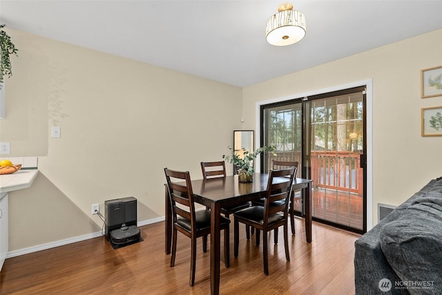 12427 129th Ave E, Puyallup, WA 98374 - dining room featuring baseboards, visible vents, and wood finished floors