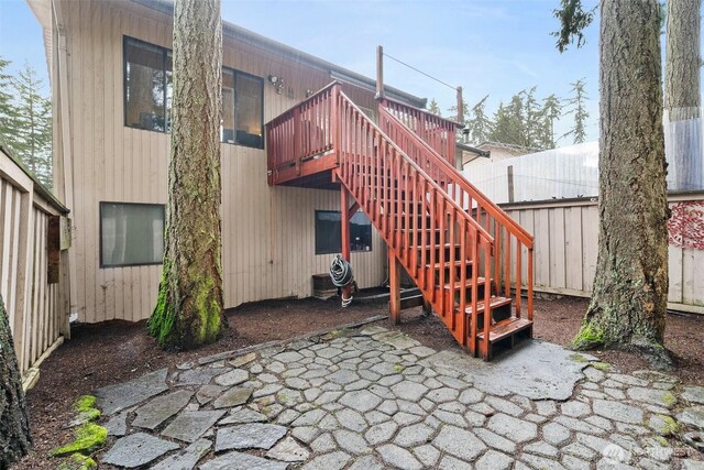 12427 129th Ave E, Puyallup, WA 98374 - back of property featuring a deck, fence, stairs, and a patio area