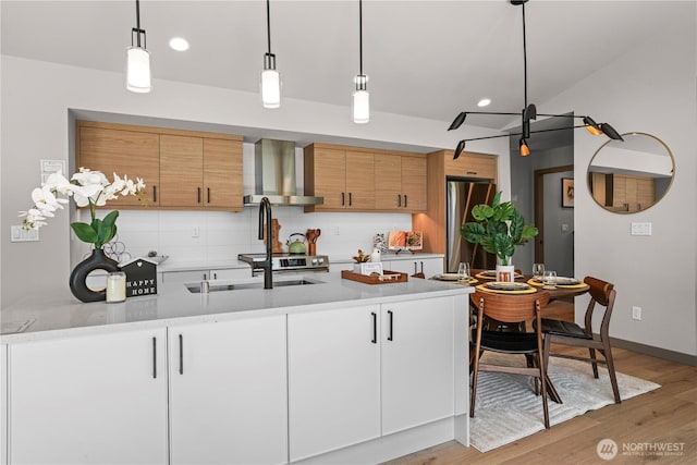 2324 NE 128th St, Seattle, WA 98125 - kitchen with wall chimney range hood, freestanding refrigerator, backsplash, light wood-style flooring, and recessed lighting