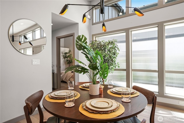 2324 NE 128th St, Seattle, WA 98125 - dining area featuring healthy amount of natural light, light wood-style flooring, and a high ceiling
