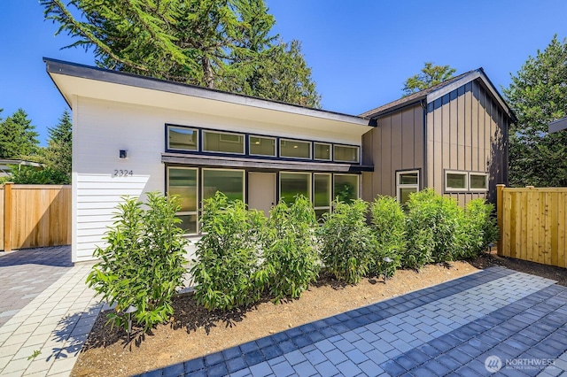 2324 NE 128th St, Seattle, WA 98125 - back of property with board and batten siding and a patio