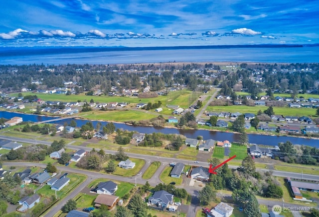 birds eye view of property with a water view and a residential view