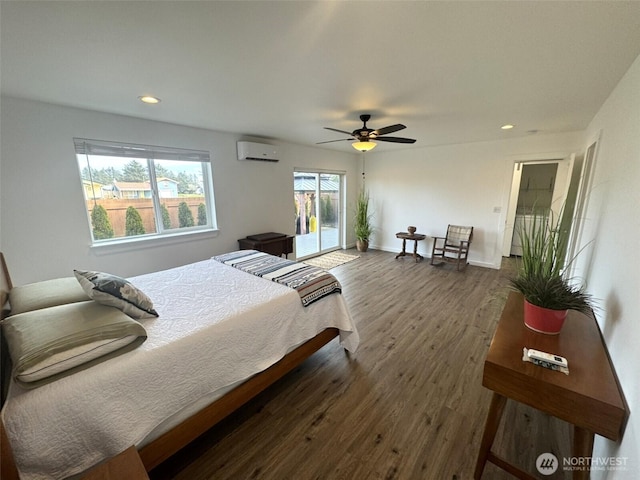 bedroom with multiple windows, access to exterior, a wall mounted air conditioner, and dark wood-type flooring