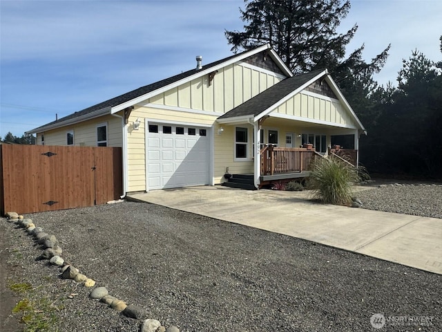 view of front of property with fence, an attached garage, board and batten siding, gravel driveway, and a porch