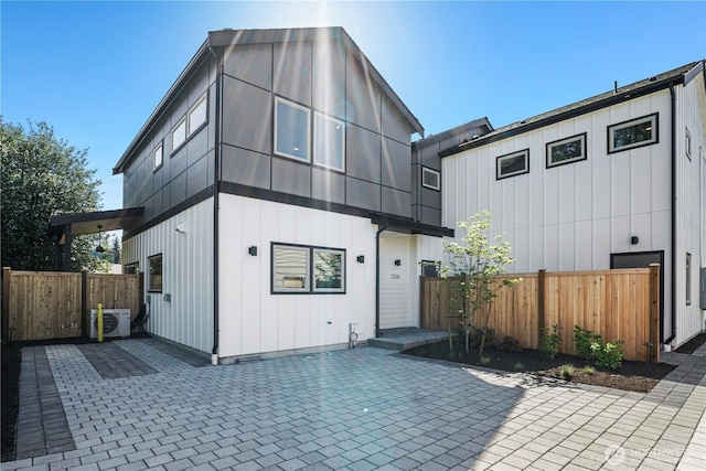 view of front of home featuring a patio and fence