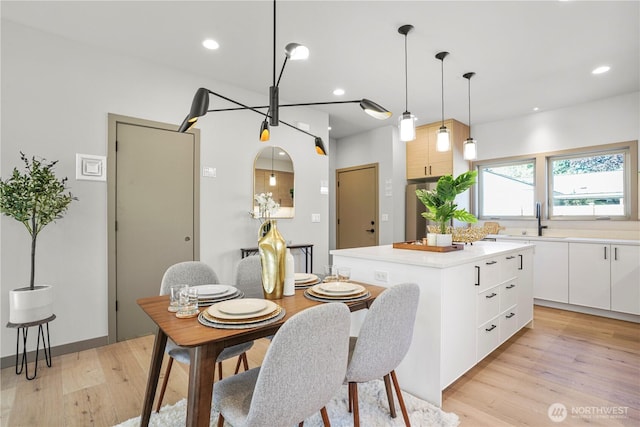 dining room featuring light wood-type flooring and recessed lighting