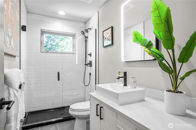 full bath with a shower stall, toilet, vanity, and tile patterned flooring