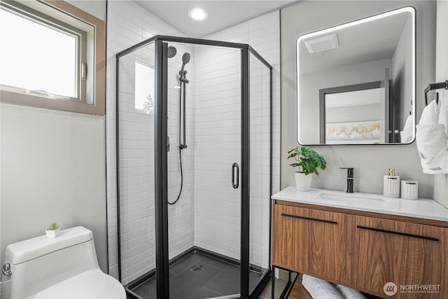 full bathroom with a shower stall, toilet, recessed lighting, and vanity