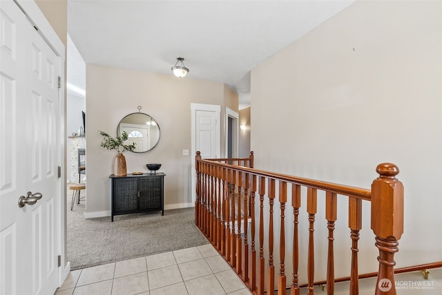 11320 S Stangland Rd, Medical Lake, WA 99022 - hall with light tile patterned floors, an upstairs landing, baseboards, and light carpet