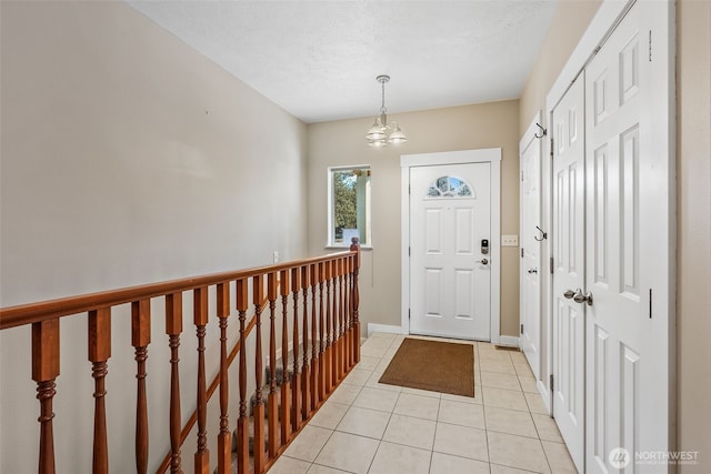 11320 S Stangland Rd, Medical Lake, WA 99022 - entrance foyer with light tile patterned floors, baseboards, a chandelier, and a textured ceiling