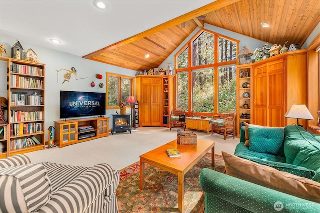 226 Ivan Rd, Friday Harbor, WA 98250 - carpeted living room featuring a wood stove, recessed lighting, high vaulted ceiling, and beam ceiling