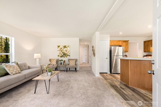 living area with light wood-type flooring and recessed lighting