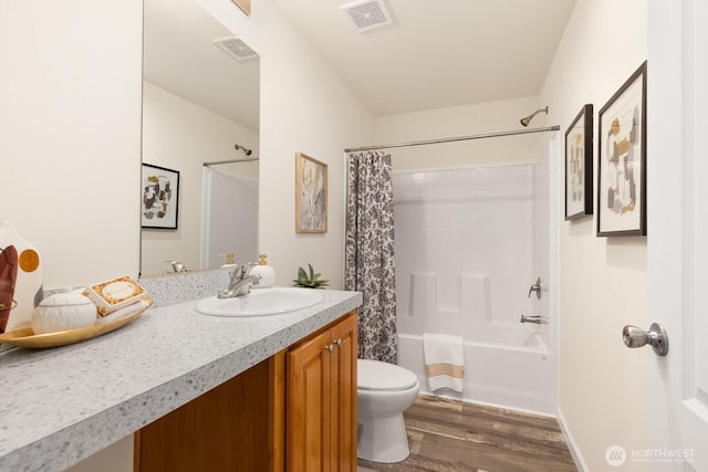 full bath featuring wood finished floors, visible vents, vanity, and toilet