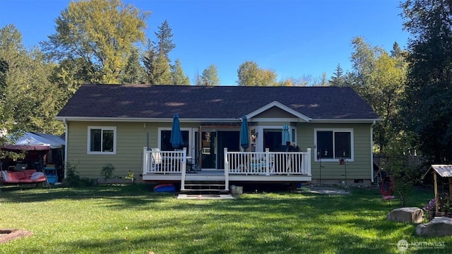 back of house featuring a yard, crawl space, and a wooden deck