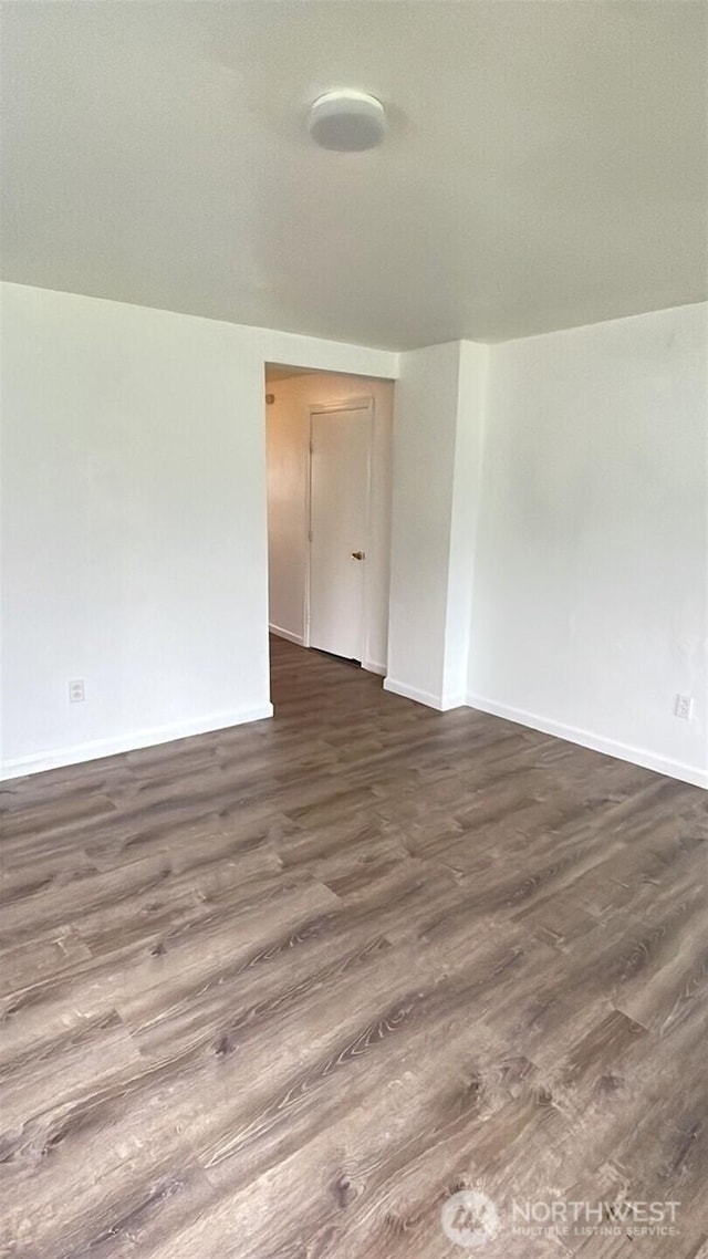 313 N E St, Aberdeen, WA 98520 - empty room featuring dark wood-type flooring and baseboards